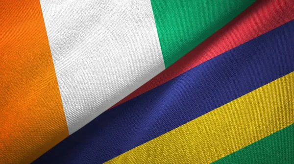 Cote dIvoire и Маврикий два флага текстильная ткань, текстура ткани — стоковое фото