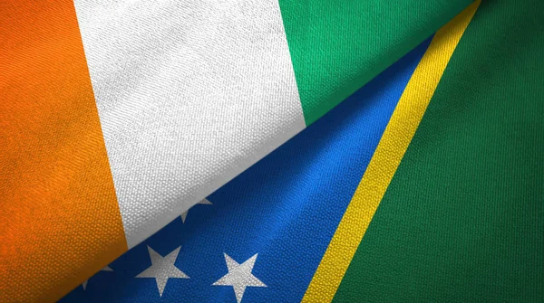 Cote dIvoire and Solomon Islands two flags textile cloth, fabric texture