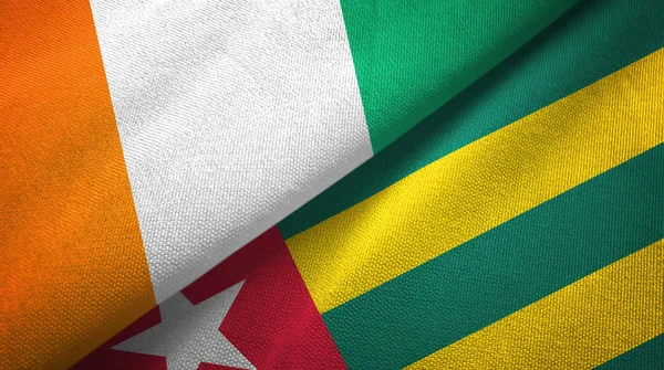 Cote dIvoire y Togo dos banderas tela textil, textura de la tela —  Fotos de Stock