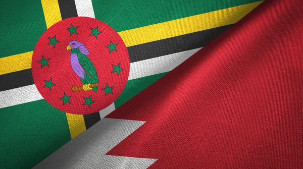 Dominica e Bahrain due bandiere tessuto, tessitura tessuto — Foto Stock