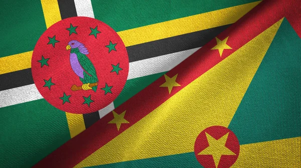 Dominica e Grenada due bandiere tessuto, tessitura tessuto — Foto Stock