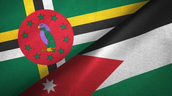 Dominica en Jordanië twee vlaggen textiel doek, weefsel textuur — Stockfoto