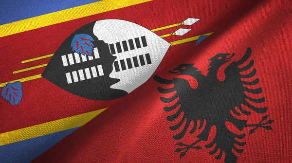 Eswatini Swaziland en Albanië twee vlaggen textiel doek, stof textuur — Stockfoto