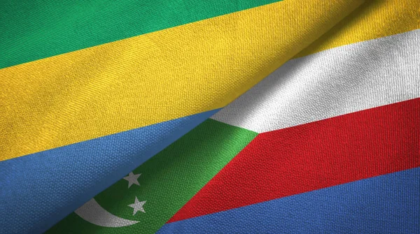 Gabão e Comores duas bandeiras de pano têxtil, textura de tecido — Fotografia de Stock