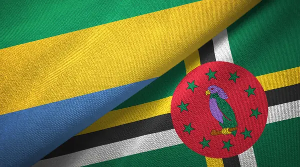 Gabon en Dominica twee vlaggen textiel doek, weefsel textuur — Stockfoto