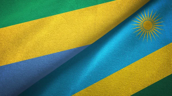 Gabon en Rwanda twee vlaggen textiel doek, weefsel textuur — Stockfoto