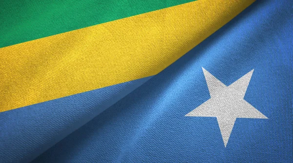 Gabon en Somalië twee vlaggen textiel doek, weefsel textuur — Stockfoto
