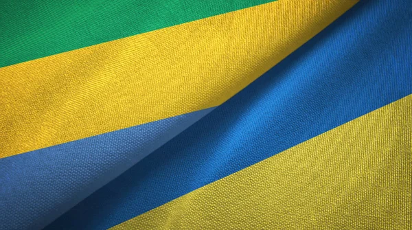 Gabon et Ukraine deux drapeaux tissu textile, texture du tissu — Photo
