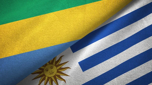 Gabon e Uruguay due bandiere tessuto, tessitura tessuto — Foto Stock