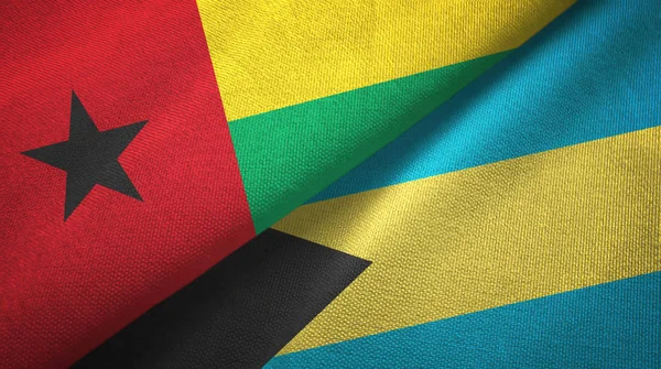 Guinea-Bissau och Bahamas två flaggor textil trasa, tyg konsistens — Stockfoto