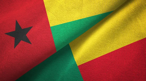 Bissau-Guinea és Benin két zászló textil ruhával, szövet textúra — Stock Fotó