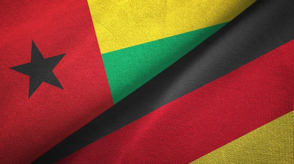 Bissau-Guinea és Németország két zászlókat textil ruhával, szövet textúra — Stock Fotó