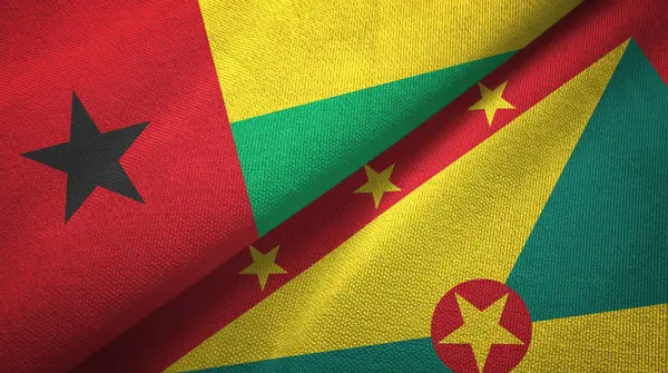 Guiné-Bissau e Granada duas bandeiras de pano têxtil, textura de tecido — Fotografia de Stock