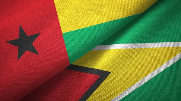 Guinea-Bissau e Guyana due bandiere tessuto, tessitura del tessuto — Foto Stock