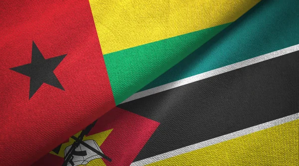 Guinee-Bissau en Mozambique twee vlaggen textiel doek, stof textuur — Stockfoto