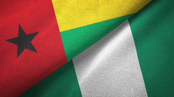 Guinea-Bissau und Nigeria zwei Flaggen Textilstoff, Textur — Stockfoto