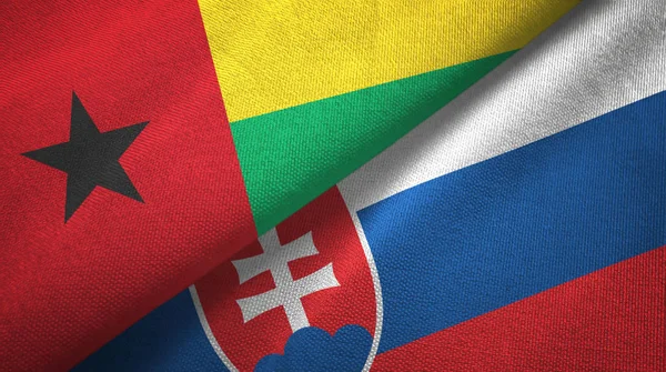 Guinee-Bissau en Slowakije twee vlaggen textiel doek, weefsel textuur — Stockfoto