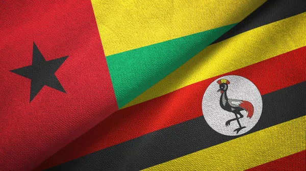 Guinea-Bissau e Uganda due bandiere tessuto, tessitura tessuto — Foto Stock