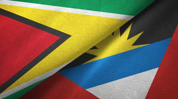 Guyana e Antigua e Barbuda due bandiere tessuto, tessitura del tessuto — Foto Stock