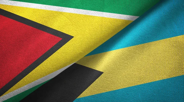 Guyana e Bahamas due bandiere tessuto, tessitura del tessuto — Foto Stock
