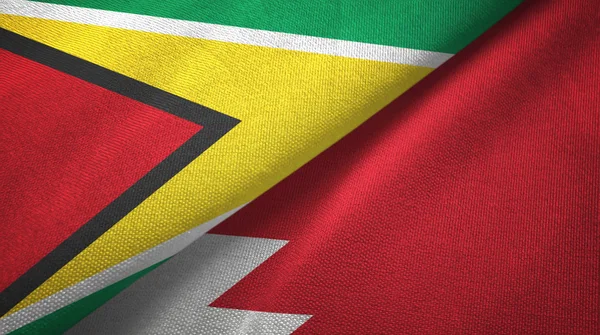 Guyana und Bahrain zwei Flaggen Textilstoff, Textur — Stockfoto