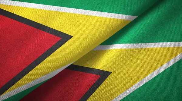 Guiana duas bandeiras de pano têxtil, textura de tecido — Fotografia de Stock