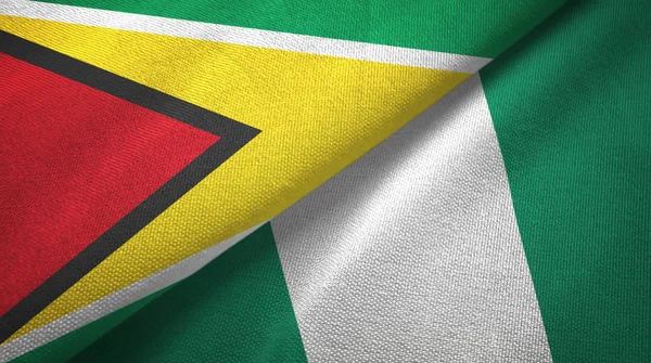 Guyana och Nigeria två flaggor textil tyg, tyg konsistens — Stockfoto