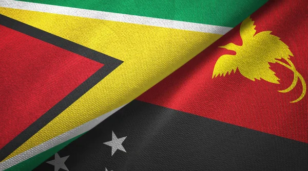Guyana e Papua Nuova Guinea due bandiere tessuto, tessitura del tessuto — Foto Stock