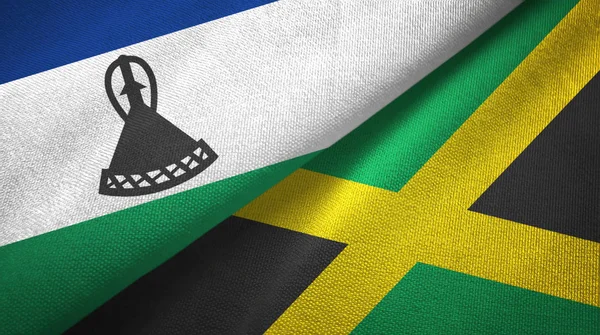 Lesotho a Jamajka dvě vlajky textilní tkaniny, textura textilií — Stock fotografie