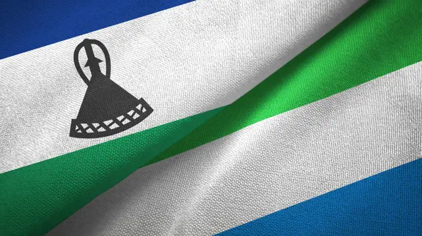 Lesotho a Sierra Leone dvě vlajky textilní látky, textura tkaniny — Stock fotografie