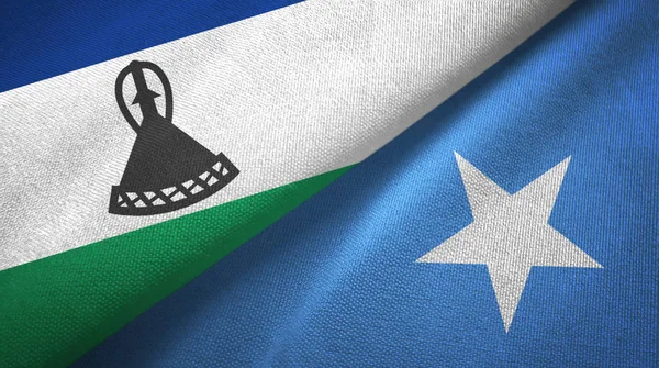 Lesotho a Somálsko dvě vlajky textilní tkaniny, textura tkaniny — Stock fotografie