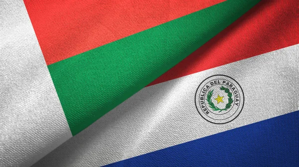 Madagascar and Paraguay two flags textile cloth, fabric texture — Stock Photo, Image