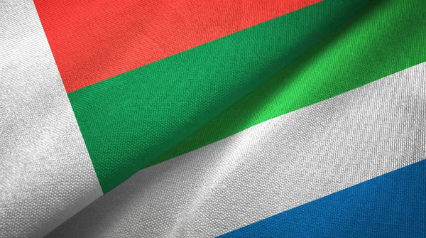 Madagascar and Sierra Leone two flags textile cloth, fabric texture — Stock Photo, Image