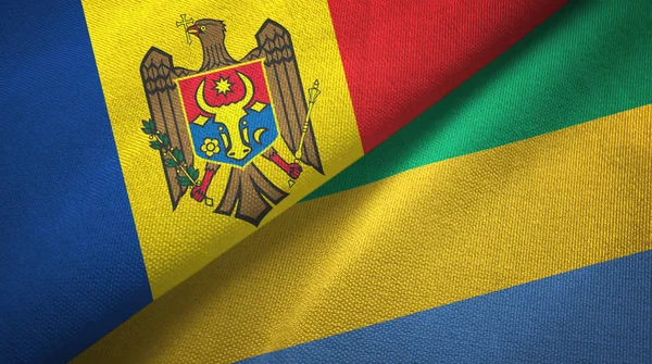 Moldávia e Gabão duas bandeiras de pano têxtil, textura de tecido — Fotografia de Stock