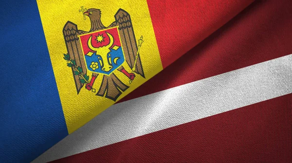 Moldova and Latvia two flags textile cloth, fabric texture — Stock Photo, Image