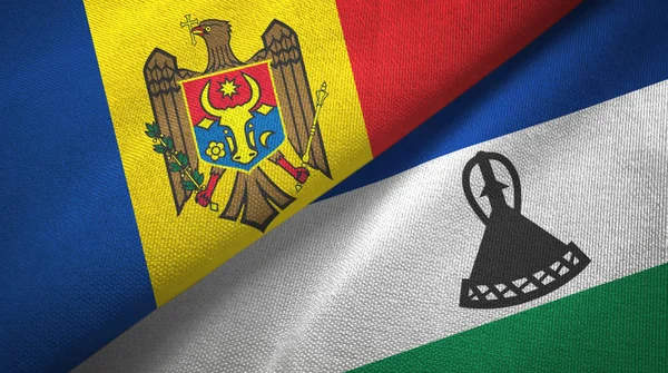 Moldavië en Lesotho twee vlaggen textiel doek, weefsel textuur — Stockfoto