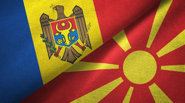 Moldávia e Macedónia do Norte duas bandeiras de pano têxtil, textura de tecido — Fotografia de Stock