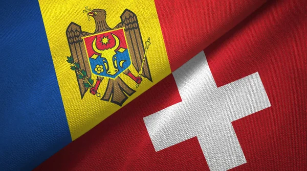 Moldavien och Schweiz två flaggor textil tyg, tyg konsistens — Stockfoto