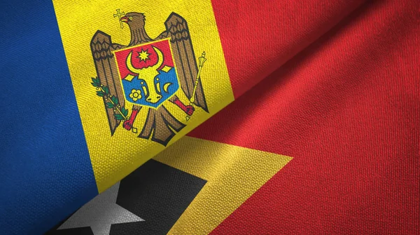 Moldavië en Timor-leste Oost-Timor twee vlaggen textiel doek, stof textuur — Stockfoto