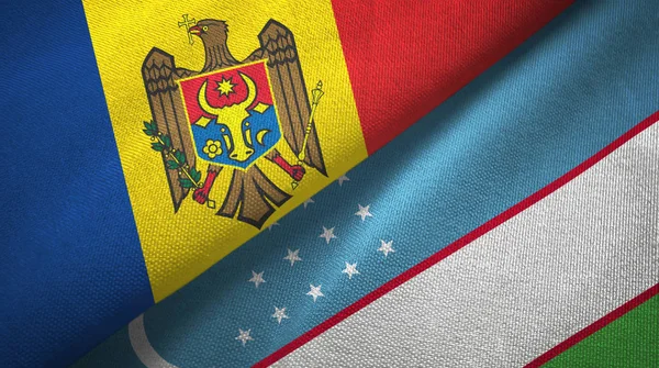 Moldavië en Oezbekistan twee vlaggen textiel doek, weefsel textuur — Stockfoto