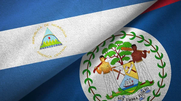 Nicaragua and Belize two flags textile cloth, fabric texture — Stock Photo, Image