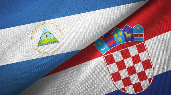 Nicaragua y Croacia dos banderas tela textil, textura de la tela — Foto de Stock