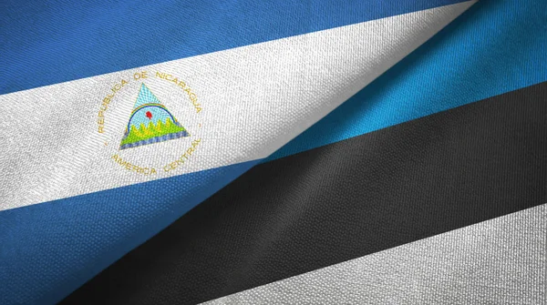 Nicaragua and Estonia two flags textile cloth, fabric texture — Stock Photo, Image