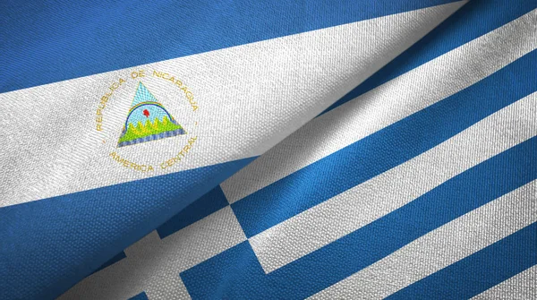 Nicaragua e Grecia due bandiere tessuto, tessitura tessuto — Foto Stock