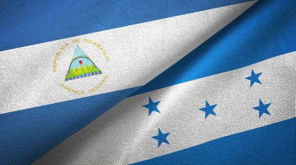 Nicaragua and Honduras two flags textile cloth, fabric texture — Stock Photo, Image