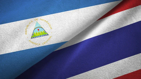 Nicaragua and Thailand two flags textile cloth, fabric texture — Stock Photo, Image