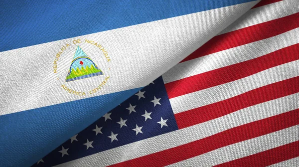 Nicaragua and United States two flags textile cloth, fabric texture — Stock Photo, Image