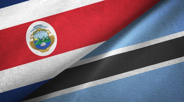 Costa Rica och Botswana två flaggor textil tyg, tyg konsistens — Stockfoto