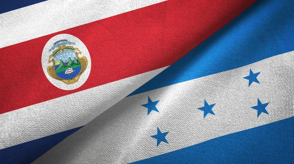 Коста-Ріка і Гондурас два прапори текстильної тканини, тканина текстура — стокове фото