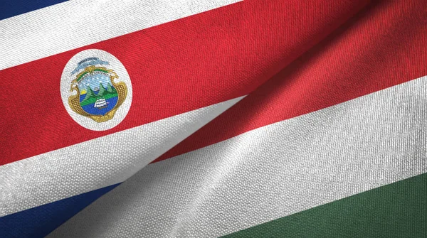 Коста-Ріка і Угорщина два прапори текстильної тканини, тканина текстура — стокове фото